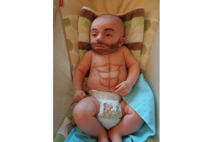 Picture of a baby with a beard and abs like father like son